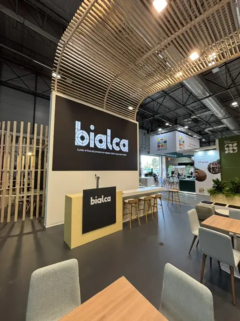 Bialca stand with timber slat ceiling, brand wall and bar with tap